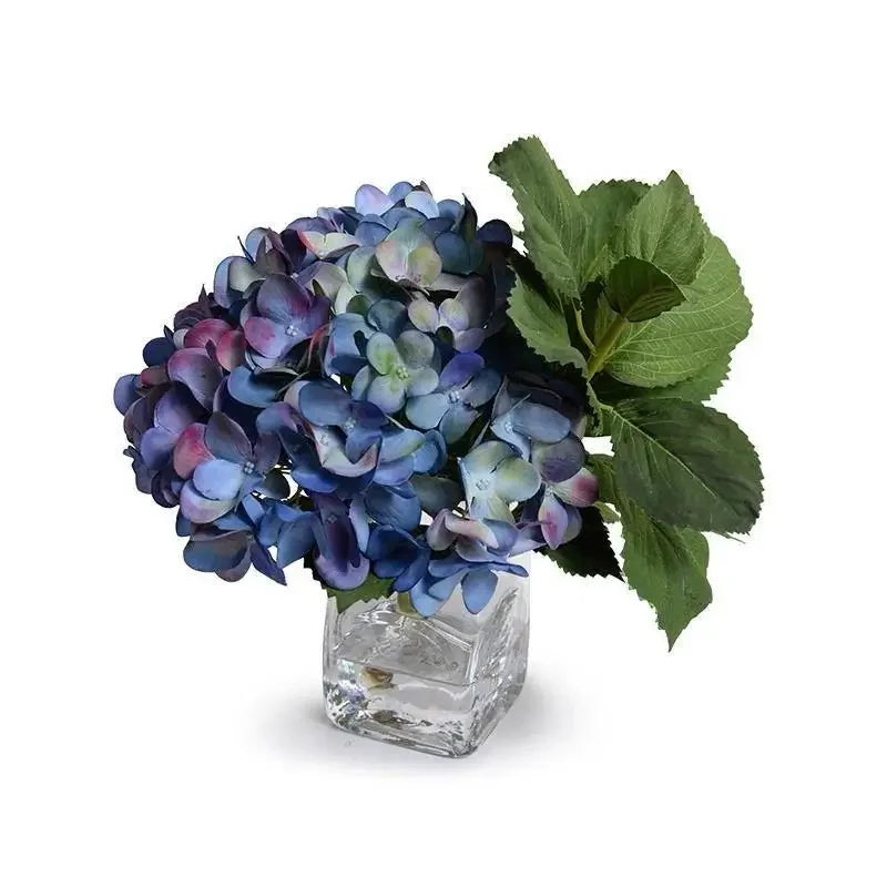 Blue Vibe Arrangement featuring a single blue hydrangea in a glass vase, available with same-day flower delivery in Manhattan & NYC.