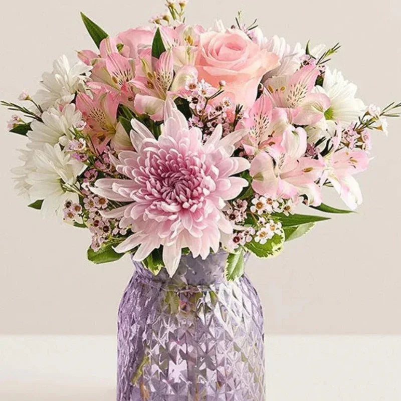 Dahlia Bloom Arrangement with pink dahlias, roses, and white blooms in a lavender vase, available for same-day delivery in Manhattan & NYC.