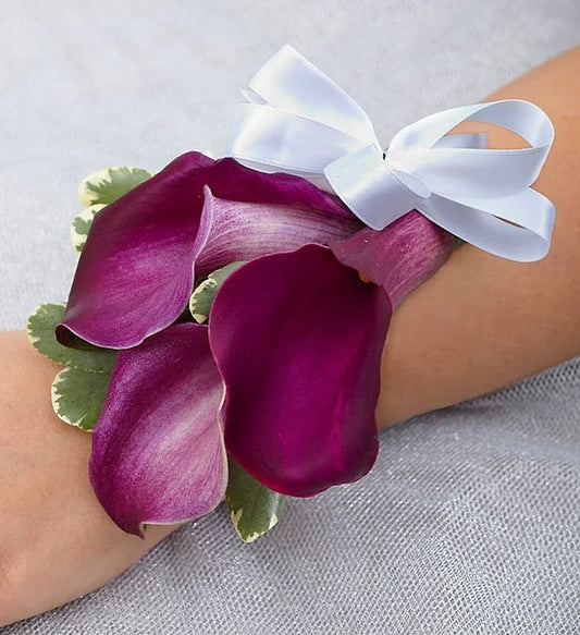 Beautiful Purple Elegance Corsage with fresh purple calla lilies and ribbon, handcrafted for weddings and proms with same-day NYC delivery.