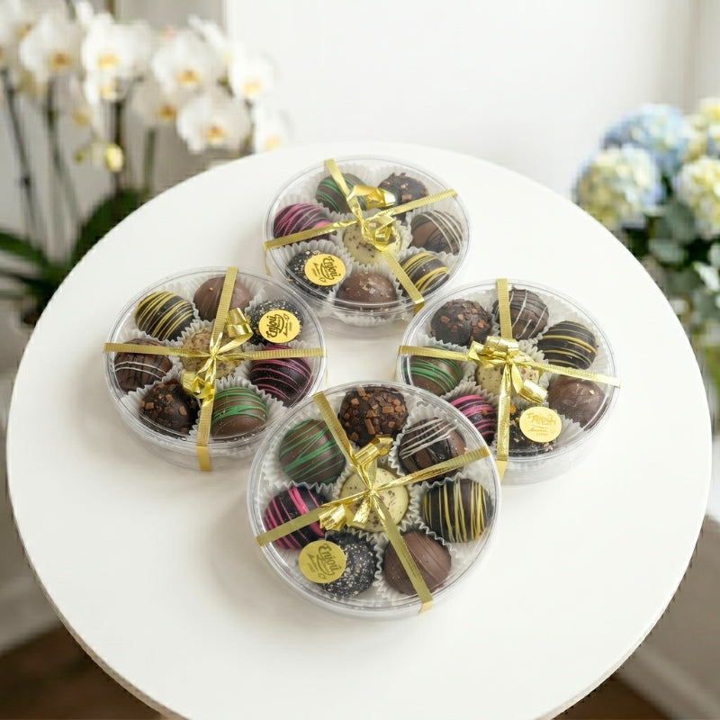 Luxury assortment of gourmet chocolate truffles in round gift boxes with decorative ribbons, perfect for gifting, celebrations, and special occasions.