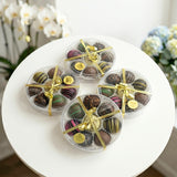 Luxury assortment of gourmet chocolate truffles in round gift boxes with decorative ribbons, perfect for gifting, celebrations, and special occasions.