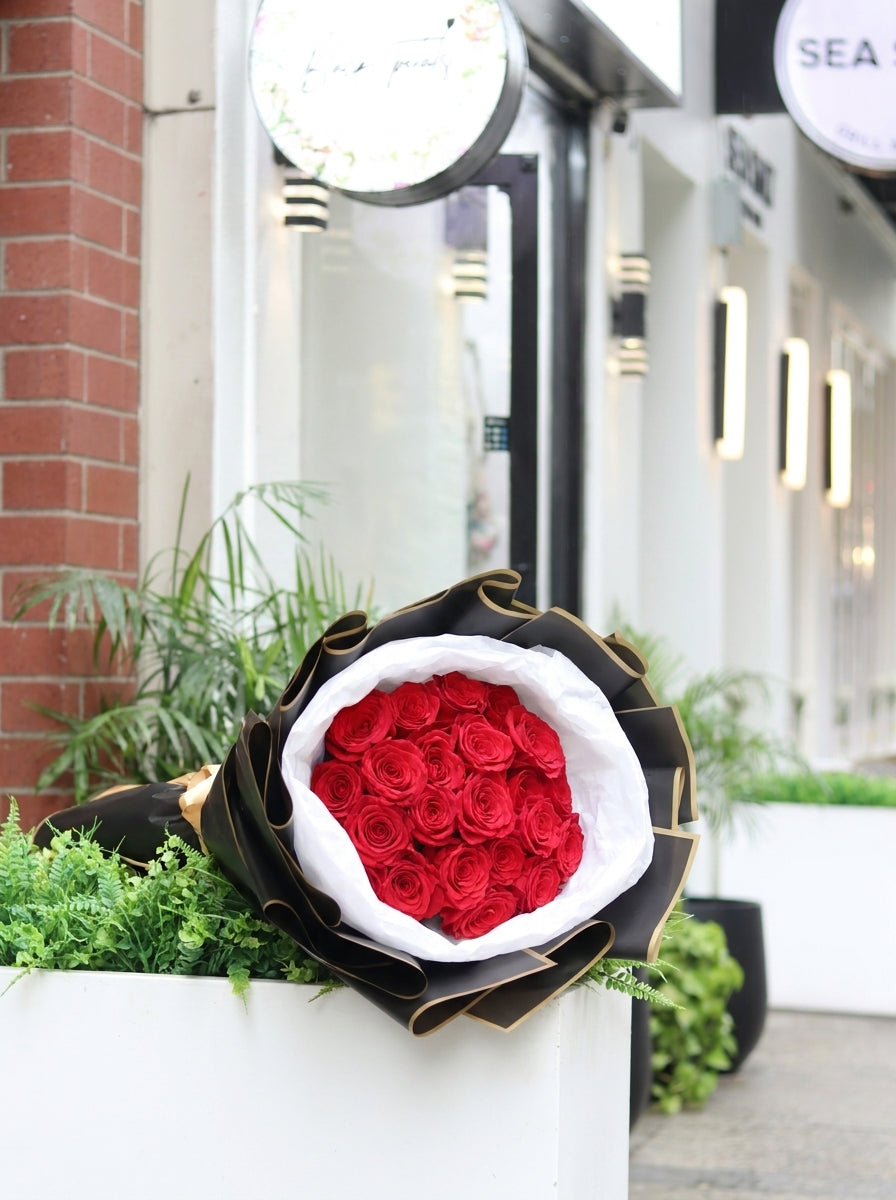Premium 36 stem red rose bouquet featuring thirty-six fresh long-stem red roses wrapped in elegant black and white premium paper, creating a luxurious gift for anniversaries, Valentine's Day, proposals, birthdays, and romantic celebrations.