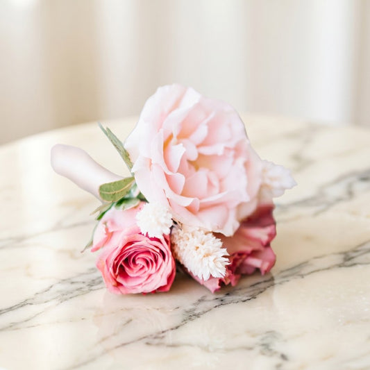 Luxury pink rose prom flowers arranged as corsage and boutonniere se