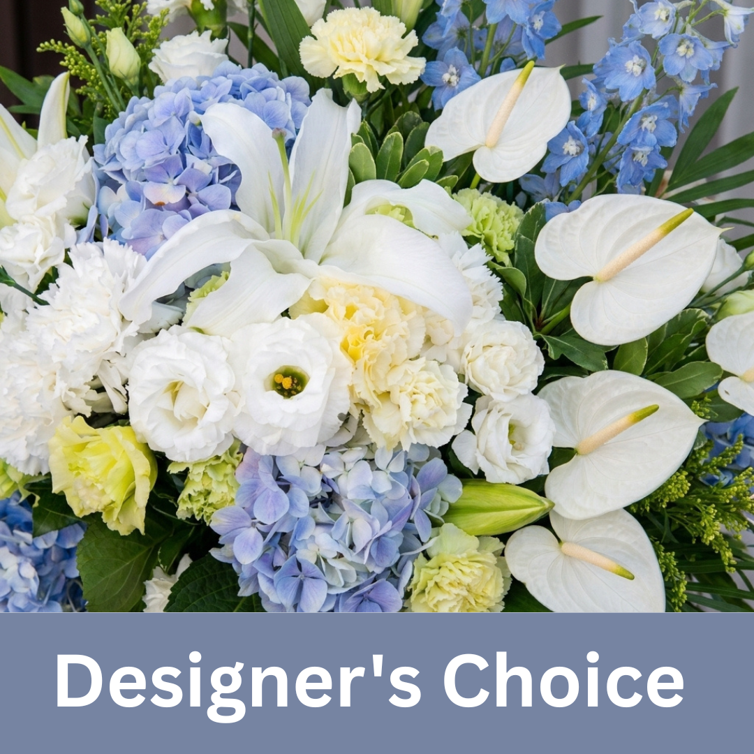 Designer's Choice Blue Flower Arrangement featuring white lilies, blue hydrangeas, white anthuriums, white carnations, white lisianthus, and fresh seasonal greenery, expertly handcrafted by local florists for sympathy, celebrations, birthdays, and special occasions.