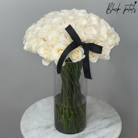 White Roses And Stems In A Glass Vase